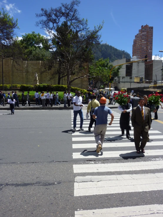 a group of people are walking on a cross walk