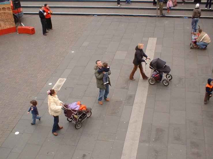 a number of people on a city street with various types of carts