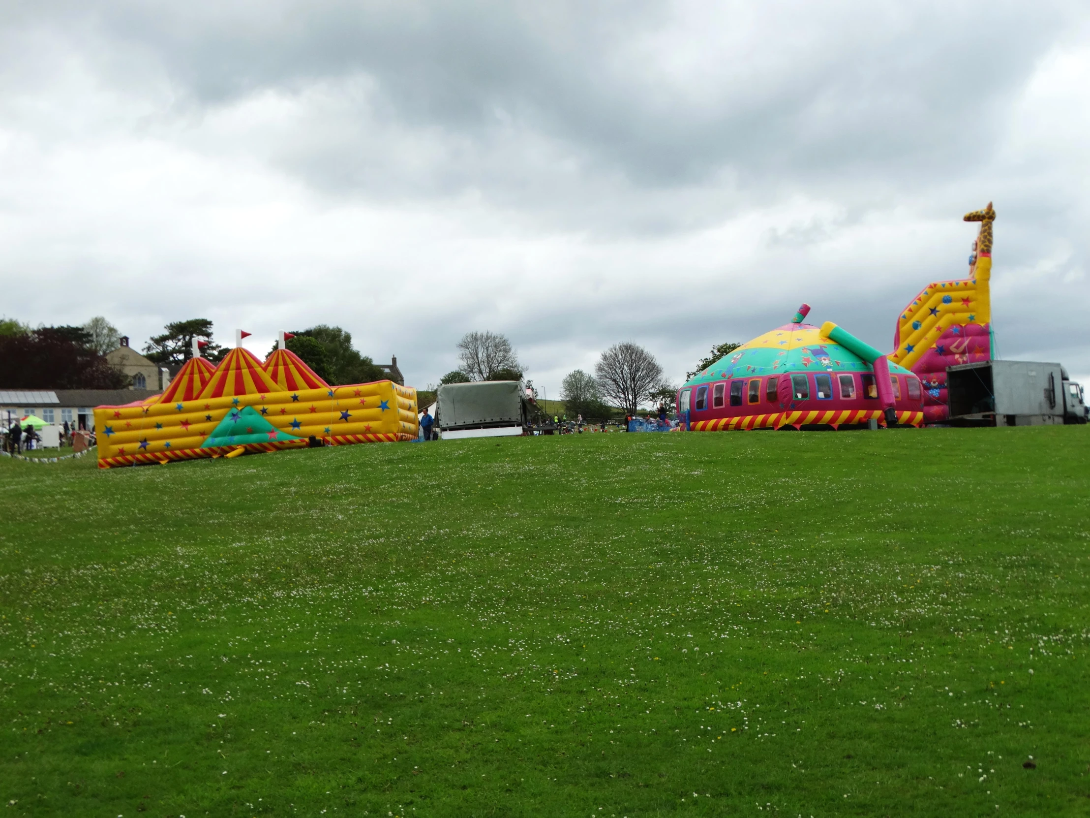 a number of inflatable animal structures with many people nearby