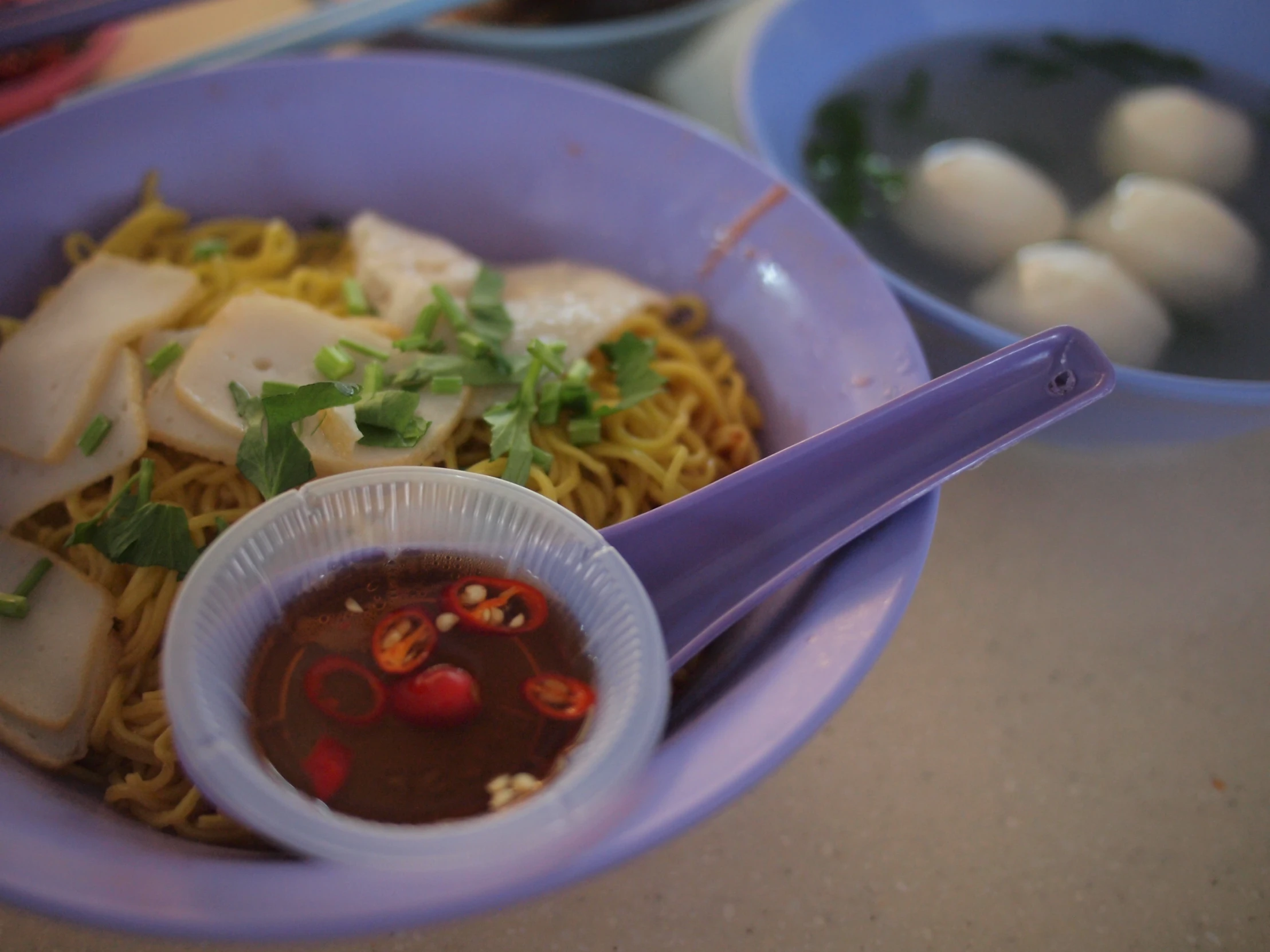 there is a bowl of food with noodles, sauce and tofu