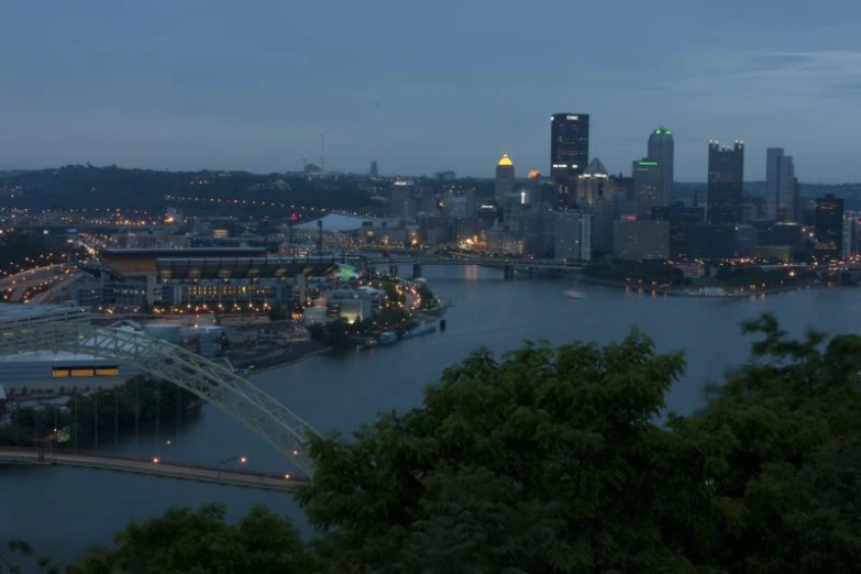 the city lights shine brightly at night along a river