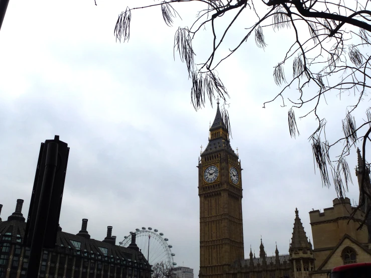 a clock tower sitting next to a tree