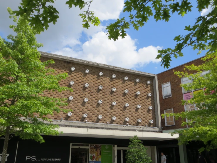 large clocks are on the side of an old brick building