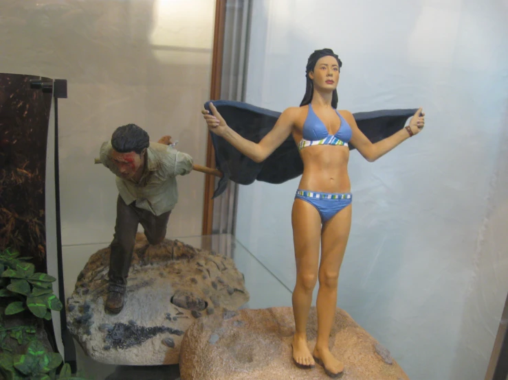 a fake woman in a blue bikini is being pographed