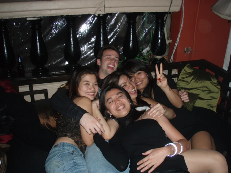 a group of people hugging, posing for the camera