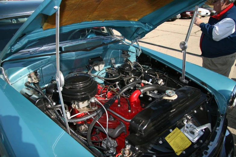 an older car with an engine in the hood