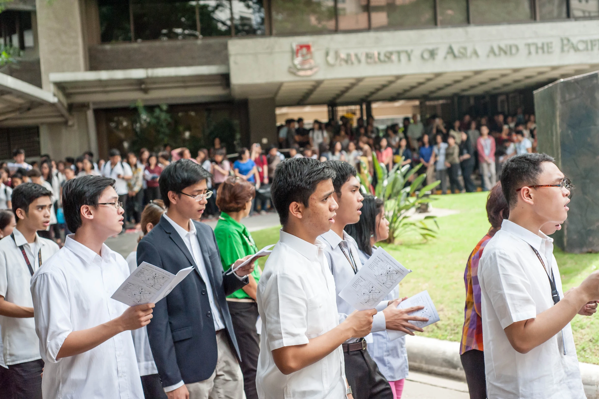 people standing in line outside with papers and papers