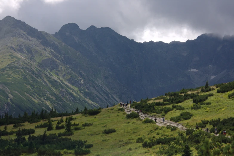 several people walking up and down the mountainside