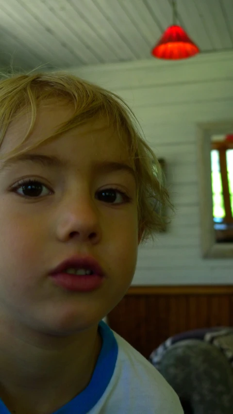 a little boy standing up with his eyes open