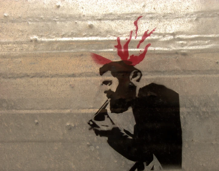 a man with a hairbrush and a cigarette is painted on a piece of glass