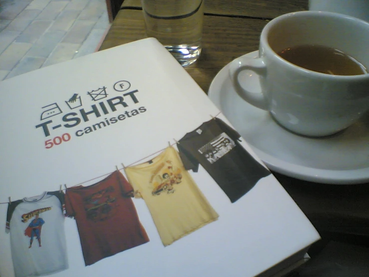 a coffee cup, a white mug and some shirts