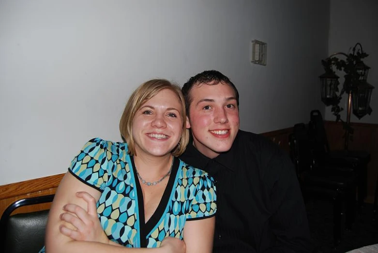 two people smiling while sitting at a table