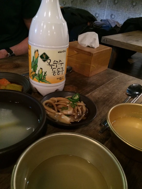 an asian food dish and bottle on a table