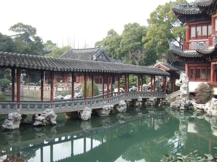 a bridge over a lake in a chinese garden