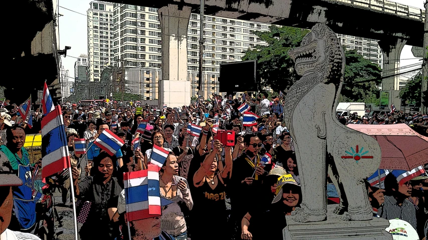 a large crowd is walking down a street together