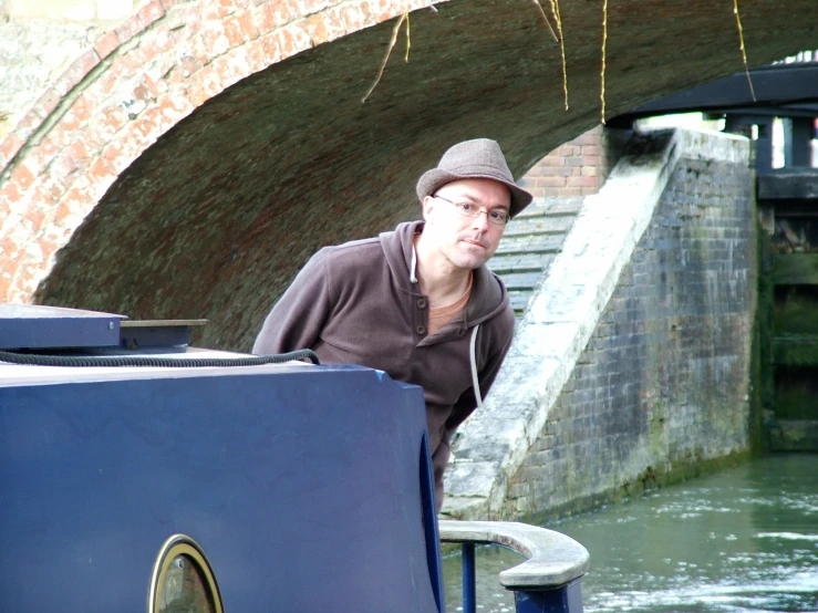 a man is on a phone while standing near the water