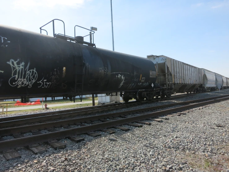 a large black train on a steel track