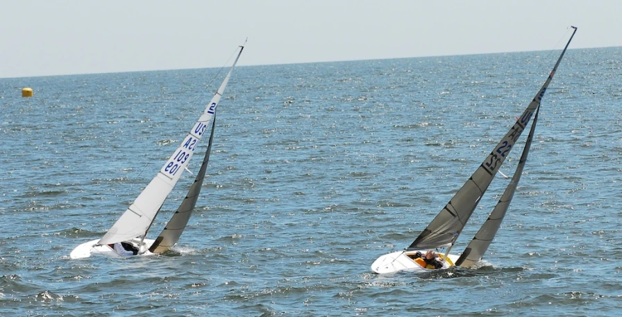 a couple of people riding on top of small boats