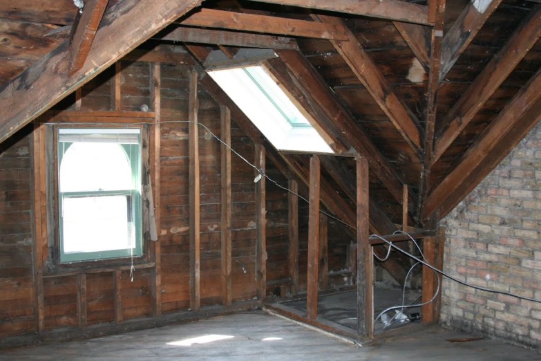 room with wooden wall and exposed floor in a loft