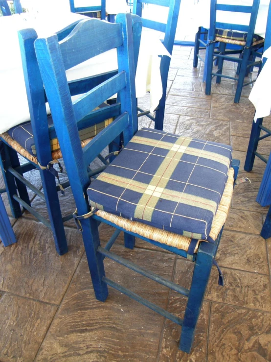 a blue kitchen chair on a tiled floor