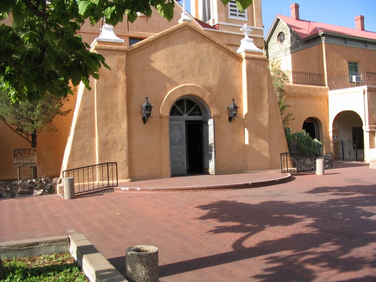 a building with a big front door next to a street