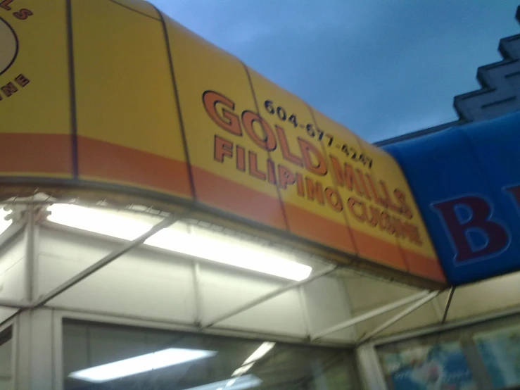 an orange and yellow advertit above the outside of a store
