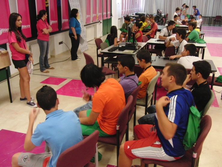 a group of s are sitting at their desks