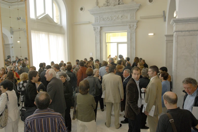 people standing in a hall near a statue