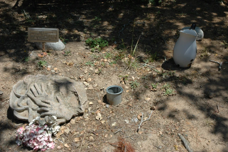 a cement bench, a bucket and a broken fire hydrant are strewn onto the ground