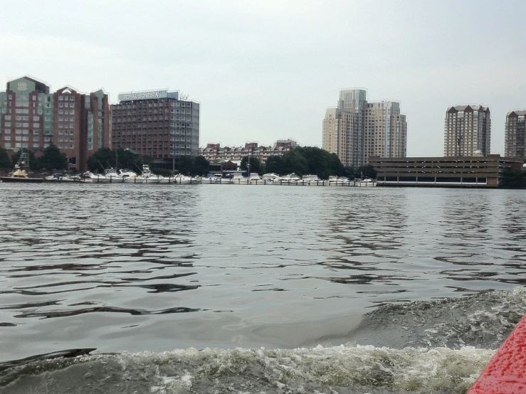 a large body of water with several buildings in the background