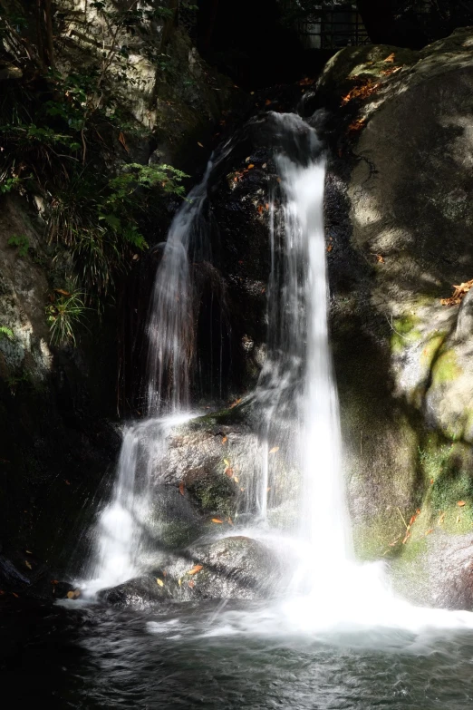 there is a waterfall and a stream running in the middle