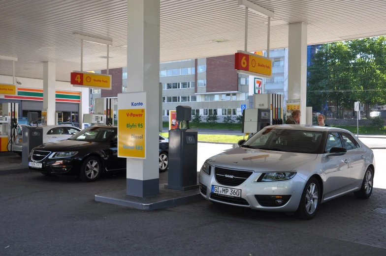 a car is parked in a service station next to other cars