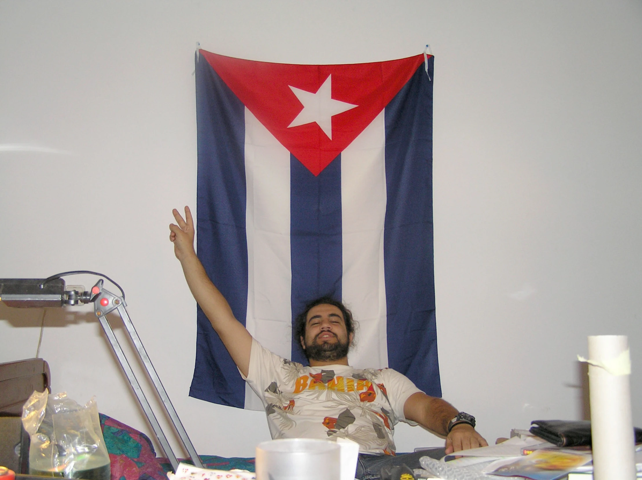 a man sitting on a chair in front of a flag