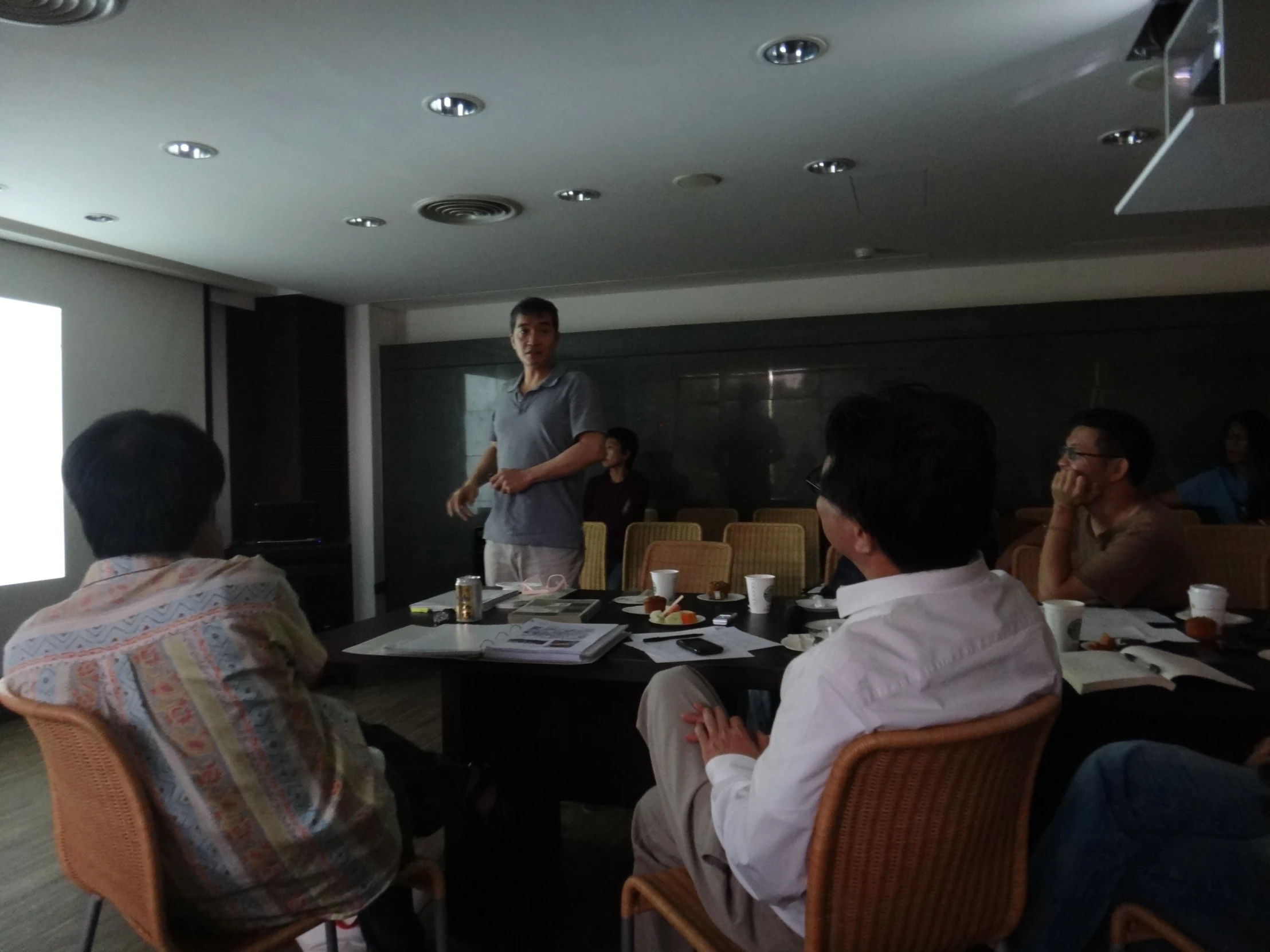 a group of people are sitting at tables in a room