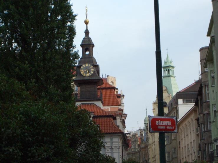 a red stop sign that has some buildings in the background