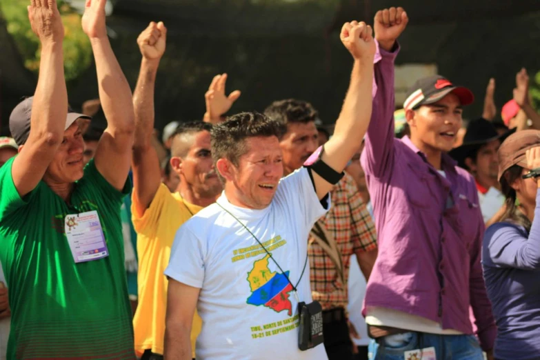 a group of people waving hands in the air