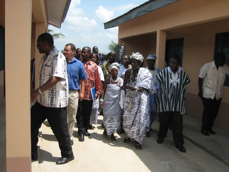 a group of people are walking near a building