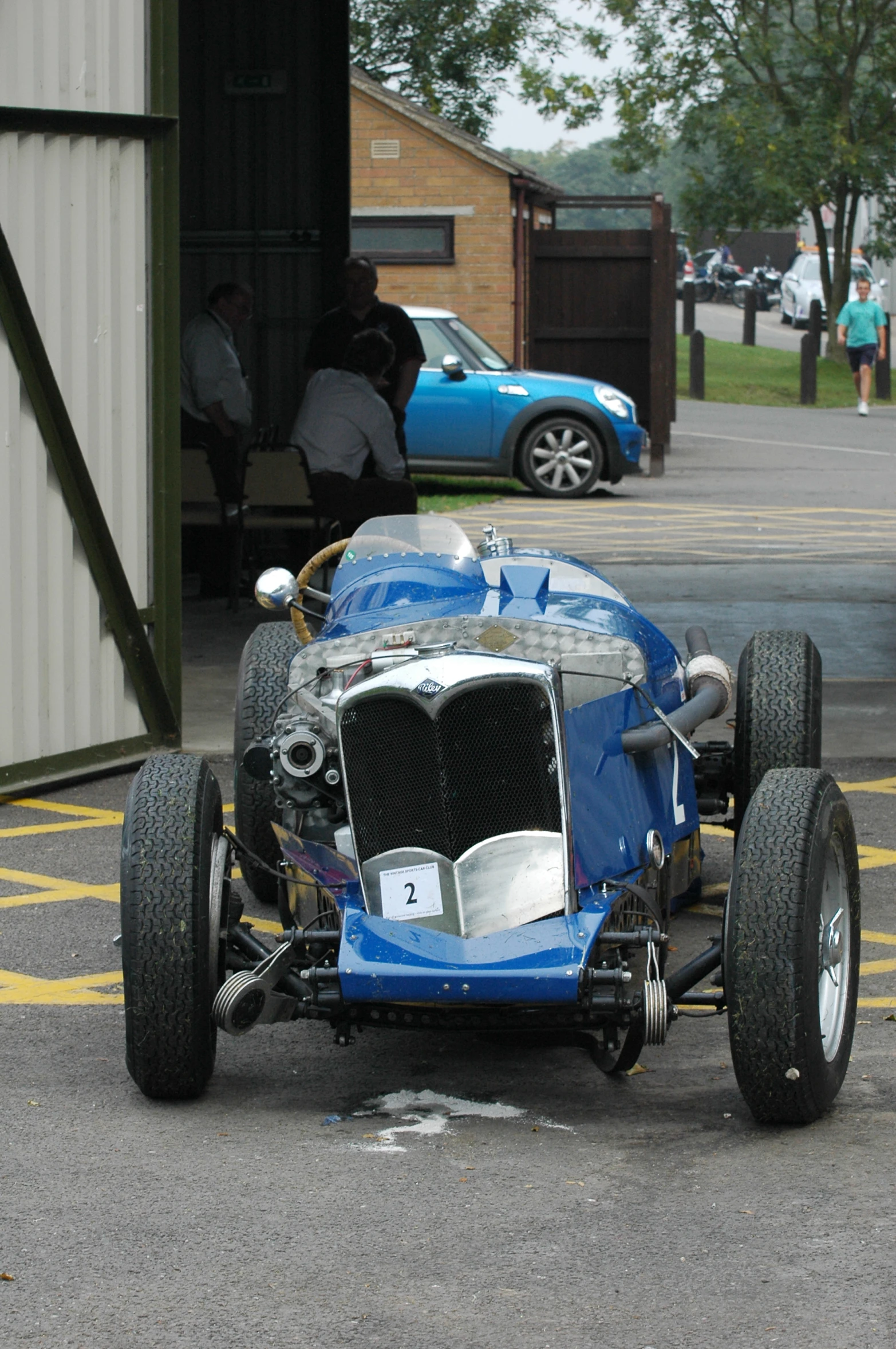 a very old race car on the side of the road