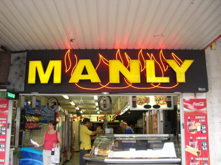 a fast food restaurant with a manly sign and food