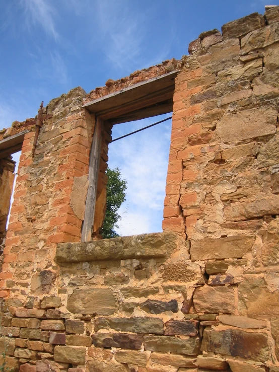 a tall brick building with a window between it