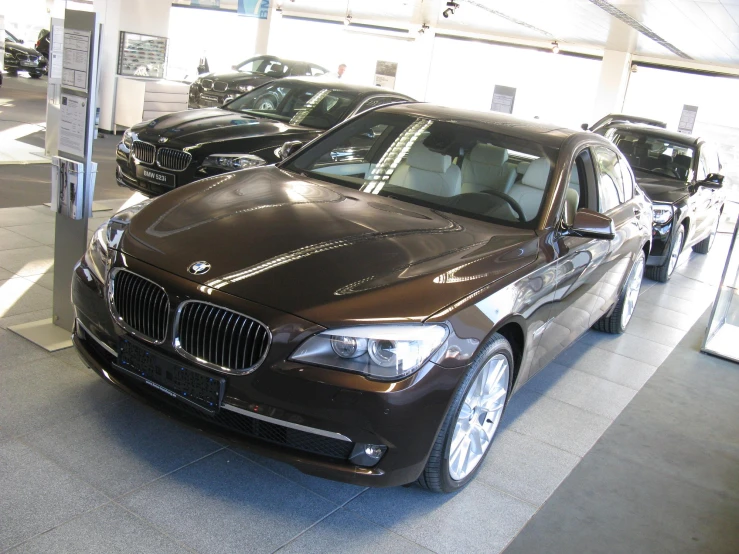 the bmw sedans are parked in the showroom