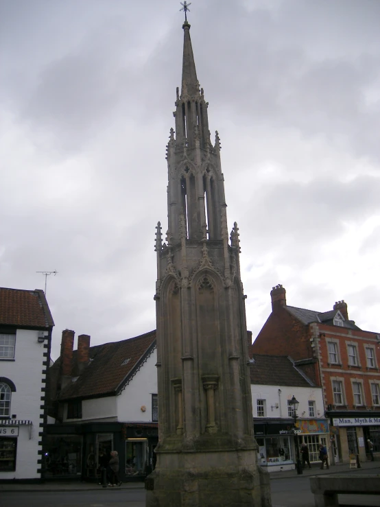 an old, stone building with towers stands in front of buildings in the city