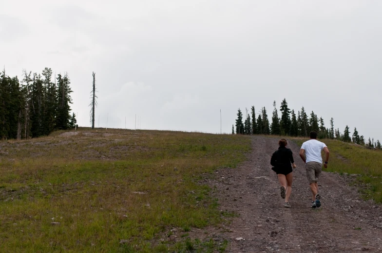 two people running down the road, one in a white shirt