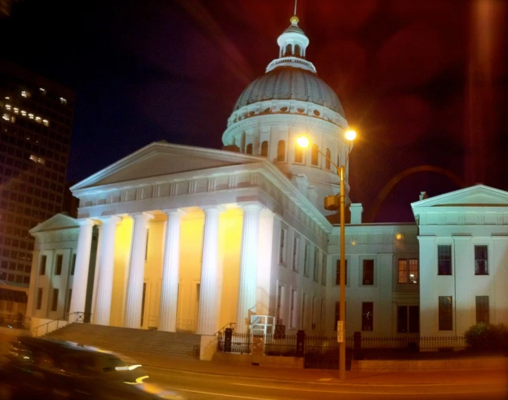 a church is lit up at night in the city