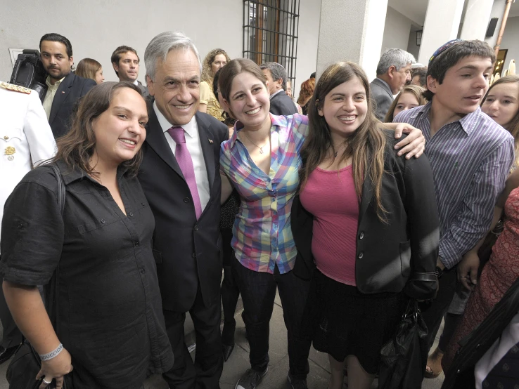 group of smiling people posing for a po