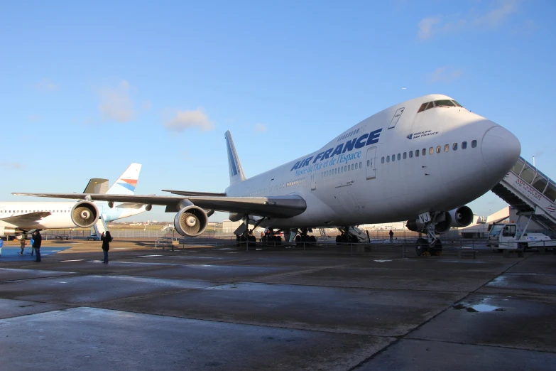 a jet sitting on top of an airport tarmac next to other planes