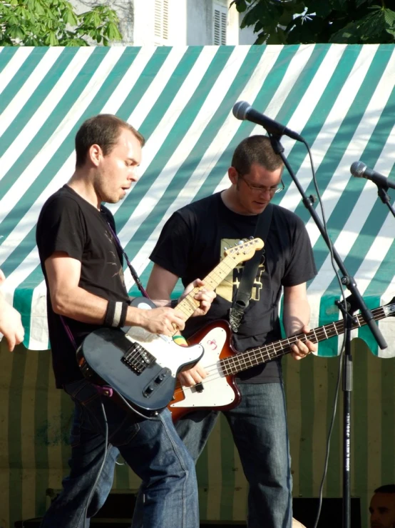 a group of people playing with guitars at a concert