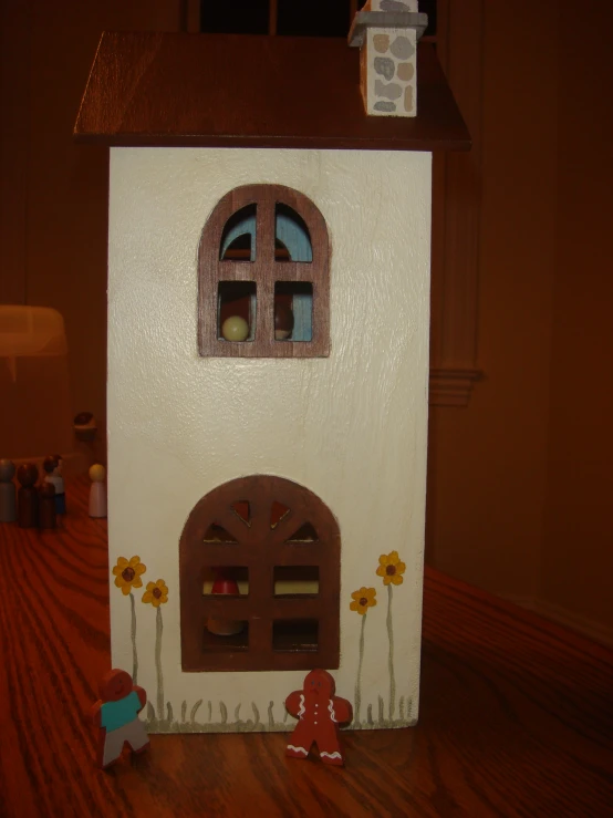 a little dollhouse with windows, doors and flowers