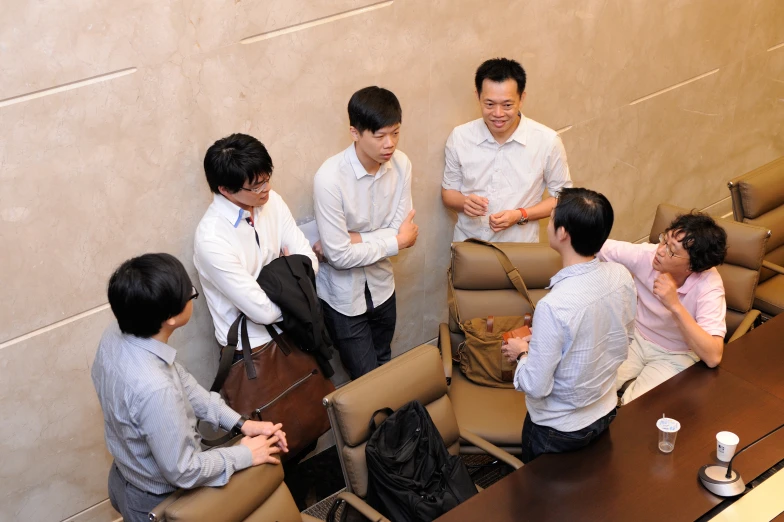 a group of men standing around each other