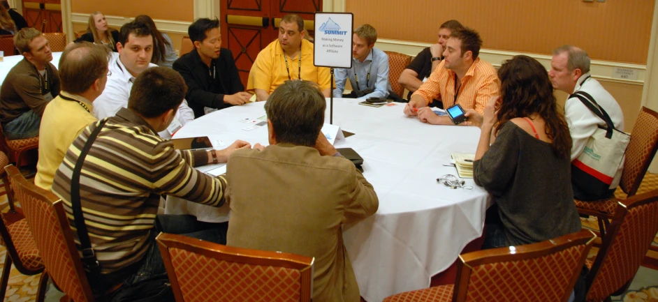 a group of people are gathered around a table